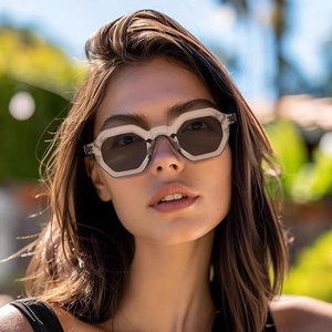 Close-up of stylish transparent grey polygon sunglasses for women in outdoor garden