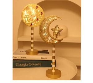Macro detail of golden crescent moon and star lamps with intricate lace pattern