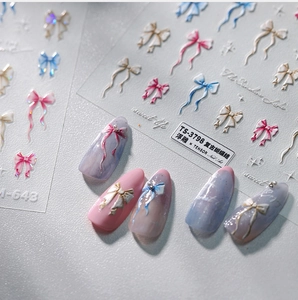Detail showing vintage embossed 3D butterfly nail stickers on gradient base nails