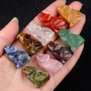 Handheld group of various natural gemstone animal carvings including tiger eye and quartz