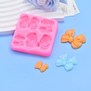 Rosa Silikonform mit Schleifenmotiven für Tortendekoration und Bastelarbeiten aus Fondant
