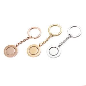 Detailed shot of rotating round metal pendants in rose gold, gold, and silver finishes