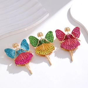 Three vintage fairy brooches with colorful rhinestones and butterfly wings on marble