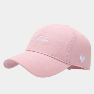Close-up of pink cotton baseball cap with white heart embroidery and side letter stitching