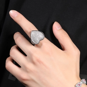 Close-up of hip-hop heart ring with 3A zircon stones worn on model hand in silver