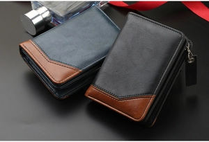 Close-up of minimalist bifold wallets in blue and black leather with vintage zip detail
