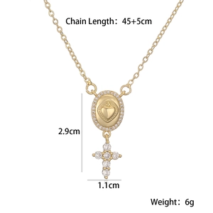 Detail view of 18K gold plated cross and heart pendant necklace with zircon stones