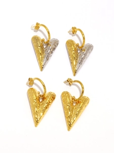 Macro detail of heart-shaped earrings featuring 18K gold plating and hammered texture