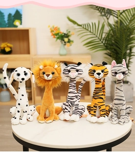 Group of long-neck plush animals like lions and tigers on a white table in a cozy room