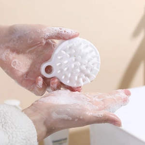 Japanese style white silicone scalp massage brush with soft bristles and easy-grip handle