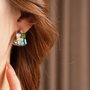 Detail of vintage geometric earrings with multi-colored crystals and sparkling rhinestones