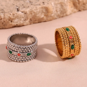 Detail of 18K gold and silver plated rings with beaded texture and colorful gemstones