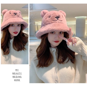 Detailed view of pink plush teddy bear bucket hat with soft fur and embroidered face