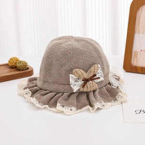 Detailed close-up of baby lace bonnet featuring checkered bow and knit texture