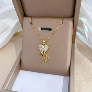 Elegant gold titanium heart gesture necklace with sparkling rhinestones on satin fabric