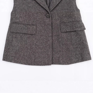 Dark grey herringbone wool blazer for women featuring single button and flap pockets