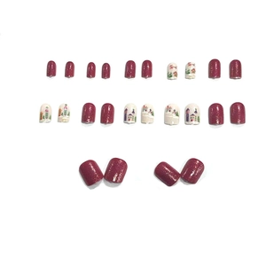 Short round red glitter press-on nails with winter village and snowman illustrations