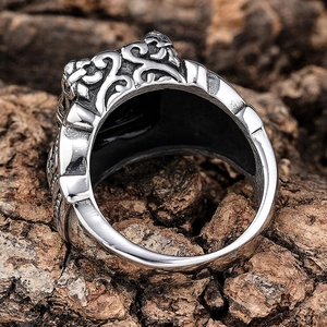 Detailed close-up of vintage stainless steel crown ring with gothic vine relief textures