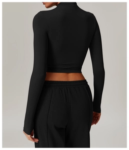 Rear view of black high-neck cropped long sleeve yoga top with slim fit athletic cut