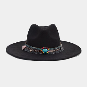 Detail of bohemian style black wide brim fedora with turquoise and tassel band