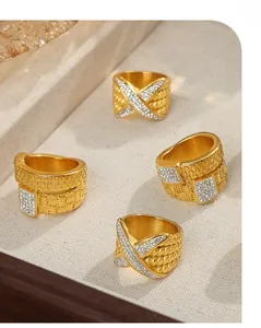 Detail of gold-plated titanium steel twist rings with micro-set crystals on fabric surface
