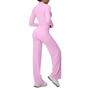 Pink three-piece yoga set with zip-up jacket and flared pants shown from back side
