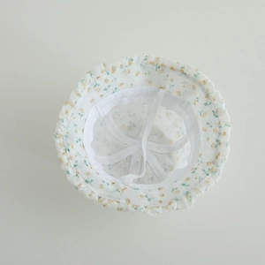 Detail of baby sun hat with floral print, ruffle brim and adjustable windproof strap