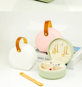 Internal details of round portable leather jewelry case with necklace hooks and slots