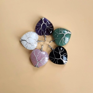 Detailed view of handmade tree of life wire wrapped heart natural stone pendants in five colors