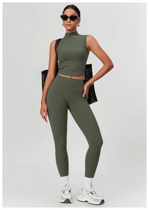 Detail of high waist olive green yoga pants and crop top with seamless elastic texture