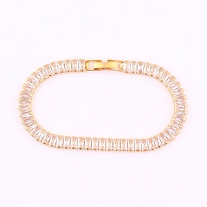 Detailed macro view of the gold-plated tennis bracelet with rectangular clear zircon stones
