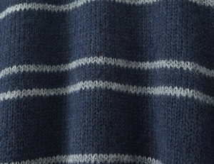 Macro detail of navy blue and grey striped knit fabric with soft wool texture