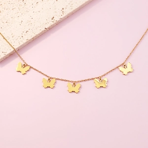 Elegant gold butterfly necklace with five smooth butterfly pendants on a minimalist chain