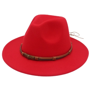 Close-up of red wide brim felt hat with leather strap and bronze skull buckle