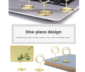 Macro detail of golden steel spiral card holder with a sleek round clip head for desk decor