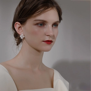 Elegant white camellia flower stud earrings shown on model for a sophisticated look