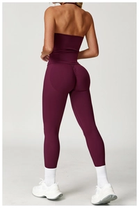 Detail of high-waist purple yoga leggings with butt-lifting seam and racerback sports top