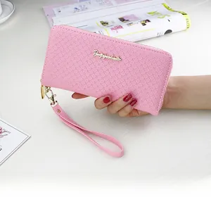 Detail of pink long wallet with cross-grain texture and gold metal logo plaque