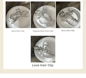 Detailed set of four silver metal hair claws including rose, bow, and Love letter shapes