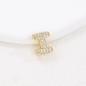 Macro shot of gold-plated letter I pendant with sparkling cubic zirconia pavé setting