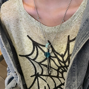 Gothic style necklace with blue heart pendant and metal tassels on bead chain