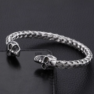 Men's punk style stainless steel twisted wire cuff bracelet with skull heads