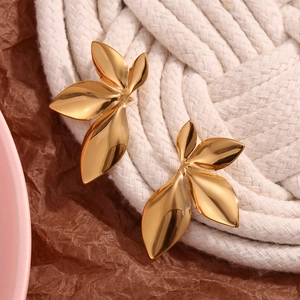 Polished 18K gold leaf earrings with three-layer metal petals on textured background