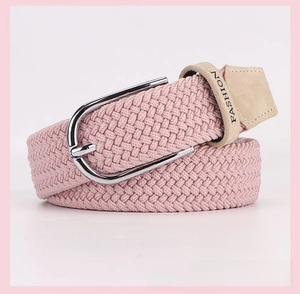 Close-up of pink braided elastic belt with silver buckle and Fashion leather tip