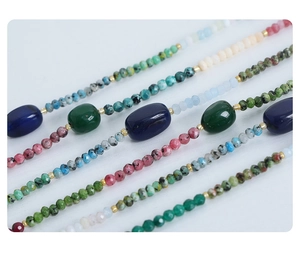 Close-up of handmade natural stone necklaces with colorful agate beads and gold spacers