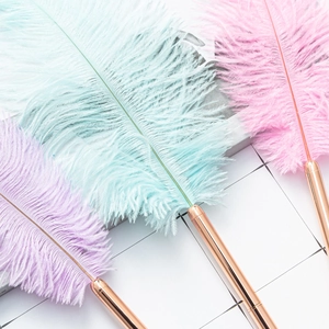 Three dreamcatcher feather ballpoint pens in pastel blue, pink, and purple with rose gold stems