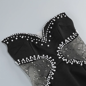 Detail of hollow out bustier dress with sequin embroidery and hand-sewn pearl beads