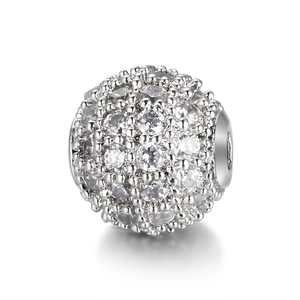Detailed view of a silver copper bead paved with clear cubic zirconia for DIY jewelry