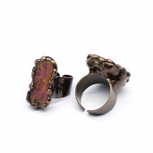 Detailed view of vintage bronze rings featuring raw pink agate geode crystals