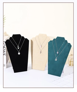 Three-color necklace display stands in black velvet, beige linen, and green velvet texture